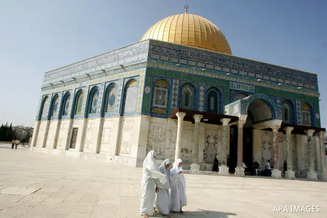 Palestinian Muslims walk in front of the Dome of the Rock on the compound known to Muslims as al-Haram al-Sharif and to Jews as Temple Mount during the fifth day of the holy month of Ramadan in Jerusalem's Old City Augus...