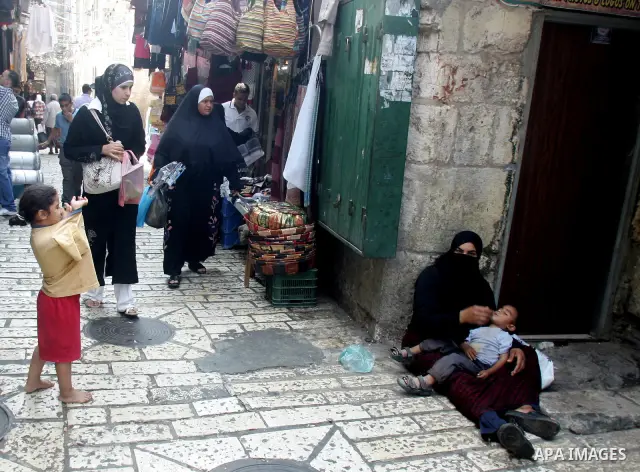 A Palestinian woman begs at a traditional market during the sixth day of the holy month of Ramadan in Jerusalem's Old City August 16, 2010. Muslims around the world abstain from eating, drinking and sexual relations from...