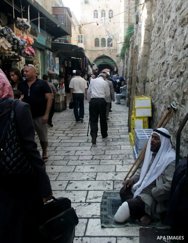A Palestinian man begs at a traditional market during the sixth day of the holy month of Ramadan in Jerusalem's Old City August 16, 2010. Muslims around the world abstain from eating, drinking and sexual relations from s...