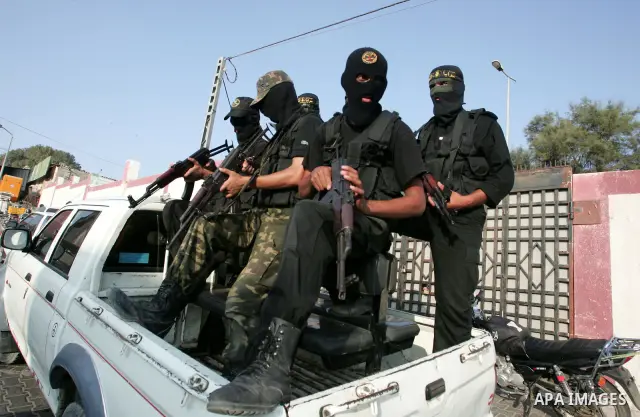 Palestinian Islamic Jihad militants participate in the funeral of Bassam Dagma, 23, at the Khan Younis refugee camp, southern Gaza Strip, Tuesday, Aug. 17, 2010. Dagma, an Islamic Jihad militant was killed Monday by Isra...