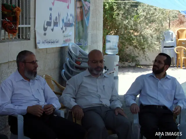 Palestinian lawmakers from Hamas movements Ahmed Atwan, Khaled Abu Arafieh and Muhammad Totah sit on the seventh day of the holy month of Ramadan at the International Red Cross Committee (ICRC), headquarter in East Jerus...