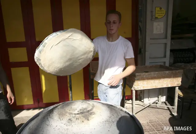 Palestinian vendor makes bread at his shop on the eighth day of the holy month of Ramadan in the West Bank city of Ramallah on August 18. 2010. Photo by Eyad Jadallah