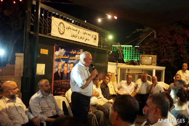 Palestinians support the lawmakers from Hamas movements Ahmed Atwan, Khaled Abu Arafieh and Muhammad Totah at the International Red Cross Committee (ICRC), headquarter in East Jerusalem August 19,2010. The Hamas lawmaker...