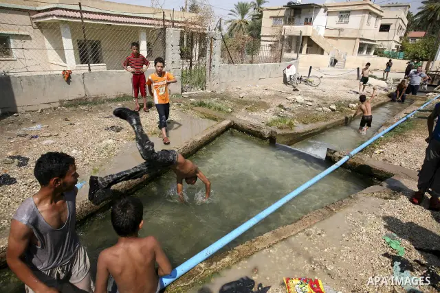 Palestinians cool off in the water of a natural spring known as Ein al-Sultan, near the West Bank city of Jericho on August 22, 2010. Photo by Eyad Jadallah