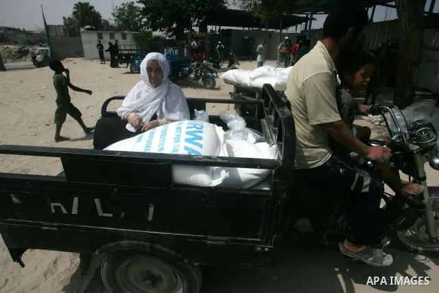 Palestinians receive their human aids from the United Nations Relief and Works Agency (UNRWA) warehouse in the southern Gaza Strip town of Rafah on August 23, 2010. Photo by Khaled Khaled