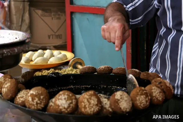 A Palestinian prepares deep fried falafel as he waits for customers several hours before Iftar, the breaking of the day long Ramadan fast in the old city of the West Bank town of Nablus, on August 23, 2010, as Muslims al...