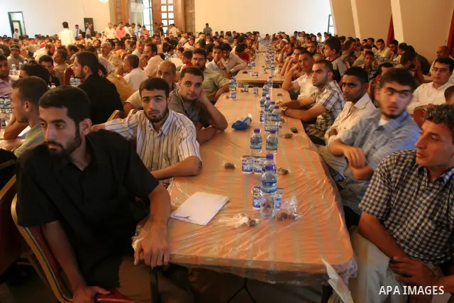 Palestinians who were injured during the Israeli war on Gaza in 2008 take their breakfast during the Islamic holy month of Ramadan with Palestinian Prime Minister in Gaza Strip, Ismail Haniyeh at al-Helaw hotel in Gaza c...