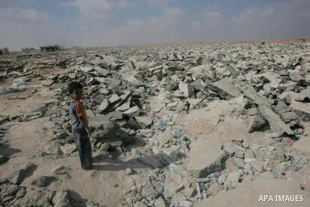 Palestinians search a destroyed runway to collect gravels at the damaged airport in Rafah, southern of Gaza Strip, August 25, 2010. Israel's blockade of the Gaza Strip was imposed after the militant Hamas group seized po...