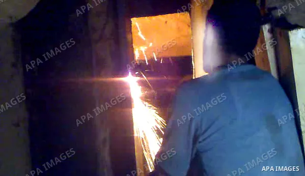 A Palestinian smuggler cuts the metal sheets underground along the border between Egypt and the southern Gaza Strip town of Rafah on August 26,2010. Egyptian Authorities constructed the metal sheets in an apparent attemp...