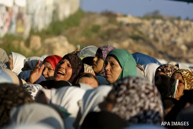 A crowd of Palestinian women wait to pass the first of several checkpoints at the Kalandia Checkpoint crossing leading from the West Bank into the Jerusalem area on 27 August 2010. Tens of thousands of people jammed the...