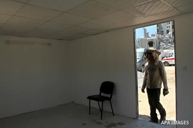 Palestinian workers from the Ministry of Transport, construct containers use as temporary shelter in the Hamas police stations instead of the destroyed stations during the Israeli war on Gaza Strip, in Gaza City on Augus...