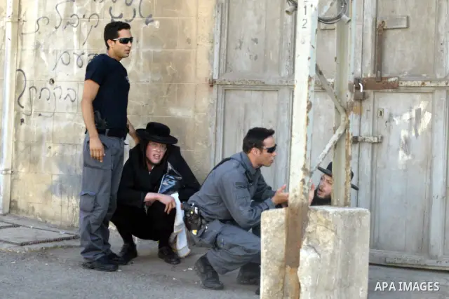 An ultra-Orthodox Jew is grabbed by an Israeli Border policeman during a protest in the coastal town of Jaffa, just south of Tel Aviv, on 29 August 2010 over the town's decision to remove ancient graves found during the...