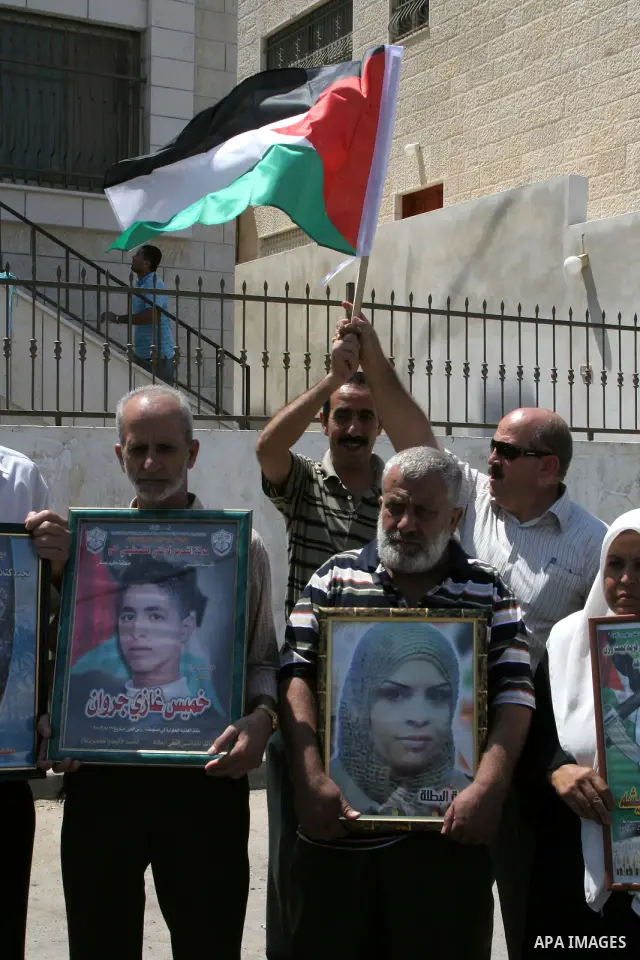 Palestinians hold pictures of relatives whose bodies remain in Israel during a protest in the West Bank city of Nablus on August 30, 2010. The families of Palestinians who were killed by the military during the First (19...