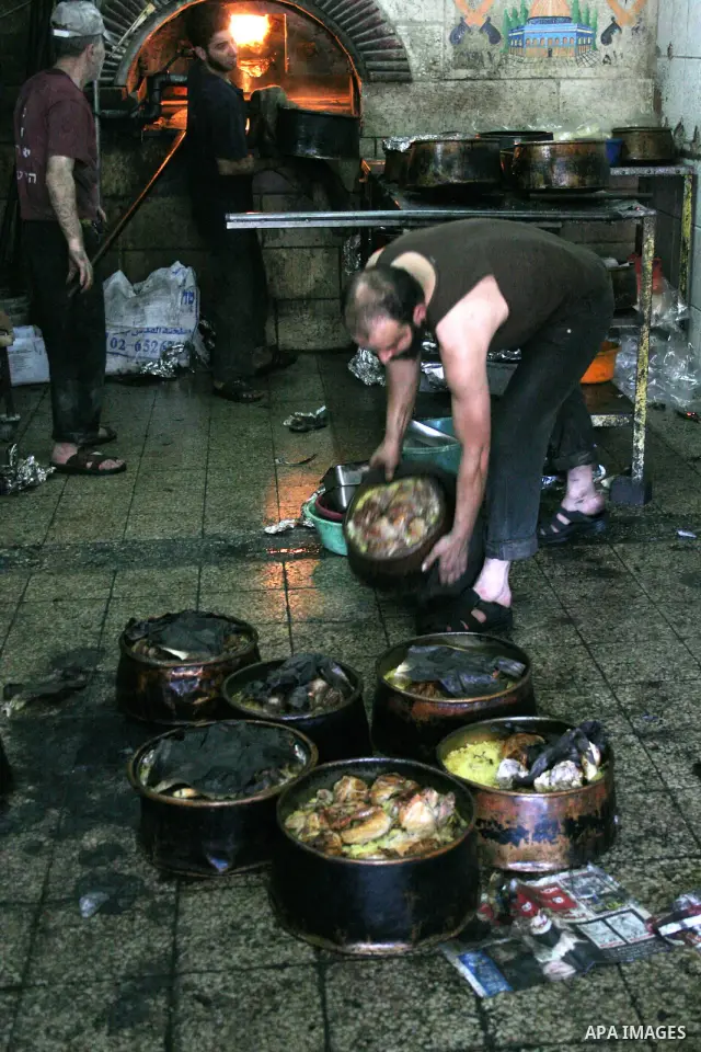 Palestinian bakers prepare jars full of rice and meat 'Qedrah" in a traditional stove in the West Bank city of Hebron on August 30, 2010 during the holy fasting month of Ramadan, when observant Muslims abstain from eatin...