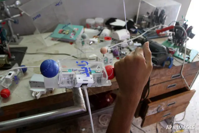 Monzer al-Qasas, a Palestinian inventor who works on electronic machine for the disabled, is seen at his home in Gaza City, on August 31, 2010. The 30-year-old man invents electronic machines to help the disabled who hav...