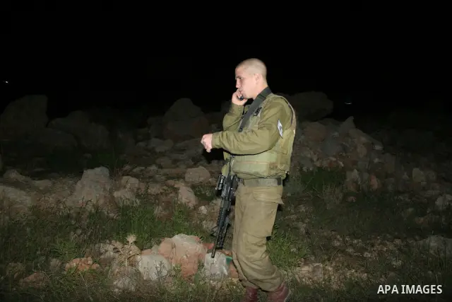 Israeli border policemen block the road after a settlers' car was ambushed by Palestinian gunmen killing two woman and two men next to Kiryat Arba settlement in the southern West Bank August 31, 2010. The military wing o...