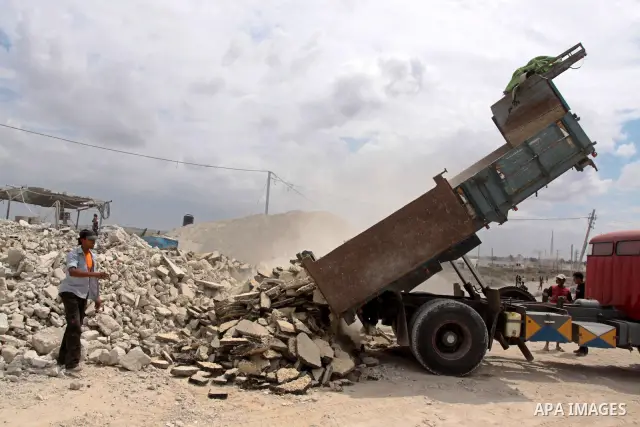 Palestinian workers reuse the rubble of the houses which destroyed during 22 days of israeli offensive on Gaza Strip for making building gravels, in Gaza City on Sept 2, 2010 . Photo by Mohammed Asad