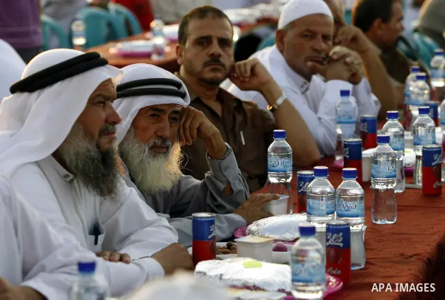 Palestinian Muslims wait to break their fast during the Islamic holy month of Ramadan, in a mass breakfast organized by Islamic Hamas movement, in Gaza City on Sept. 1, 2010. Photo by Wissam Nassar