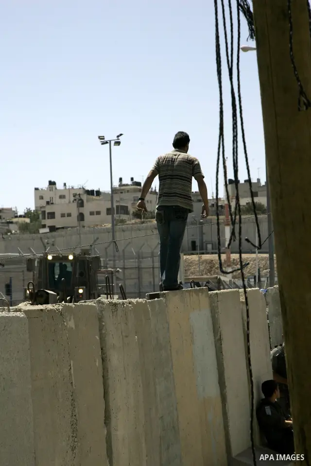 A Palestinian man tries to cross at Kalandia checkpoint between Jerusalem and the West Bank city of Ramallah, to pray at al-Aqsa mosque on the last Friday of the holy month of Ramadan, Sept. 3, 2010. Muslims throughout t...