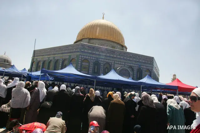 Palestinian Muslim women pray in front of the Dome of the Rock on the compound known to Muslims as al-Haram al-Sharif and to Jews as Temple Mount during the final Friday of the holy month of Ramadan in Jerusalem's Old Ci...