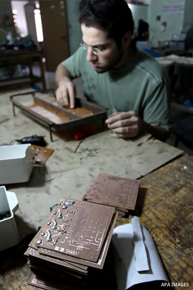 A Palestinian youth Farouk Sharaf prepares electric charger at his workshop in Gaza City on Sept 4,2010 as Gaza Strip which suffers from power outages as the lack of fuel to Gaza's power station in the city . Photo by As...
