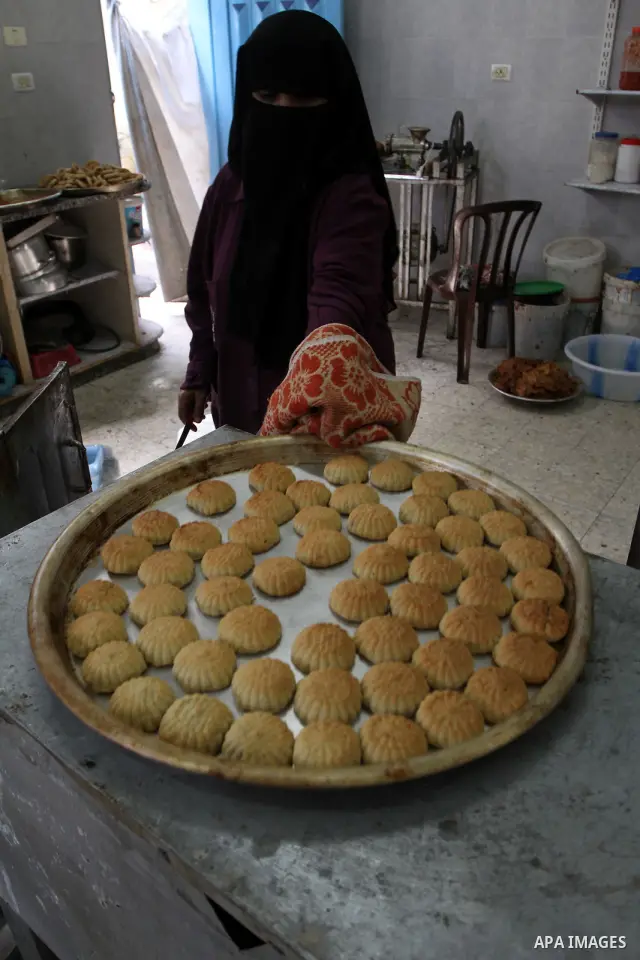 A Palestinian woman prepares date-filled mini cakes traditional for the Eid al-Fitr, a three-day holiday that marks the end of the fasting month of Ramadan, at her charity association in Gaza city, on September 6, 2010....