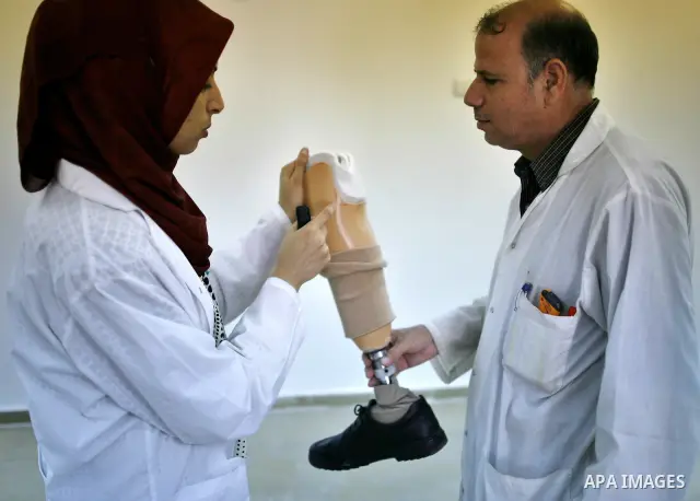 Palestinian specialists work on prosthetic legs at a medical centre making artificial limps for the victims of Gaza 2008/2009 war in Gaza City on Sept 7,2010 . Photo by Wissam Nassar