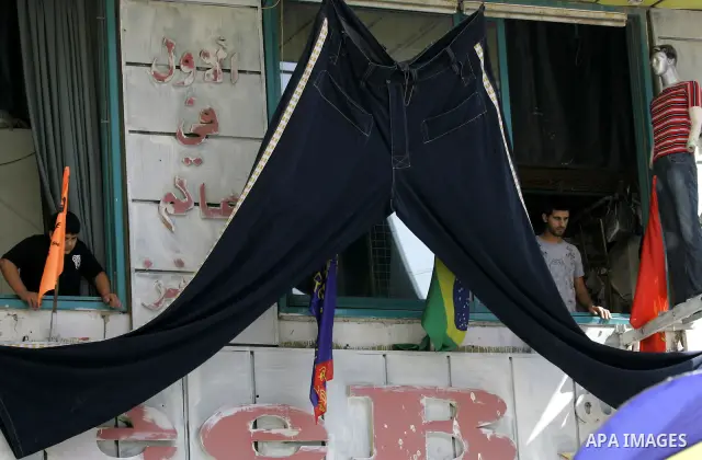 Palestinian vendors display a large trouser in the West Bank city of Nablus on Sept 7,2010 , as Muslims the world over prepare to celebrate Eid al-Fitr, a three day holiday marking the end of the religious month of Ramad...