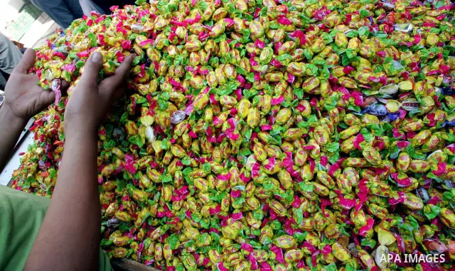 A Palestinian vendor sells sweets at a market ahead of the Eid al-Fitr, marking the end of the Muslim holy month of Ramadan in Jerusalem's Old City September 8, 2010. Photo by Mahfouz Abu Turk