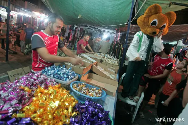 A Palestinian vendor sells sweets as Muslims shop ahead of the Eid al-Fitr celebrations in the southern Gaza Strip on Sept 9, 2010. Muslims in the region will celebrate the Eid al-Fitr holiday starting Sept. 10 with the...