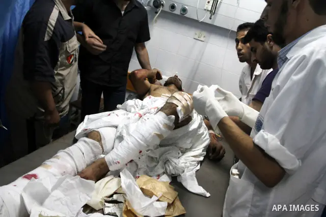 A Palestinian youth receives treatment at al-Aqsa hospital after he was wounded by an Israeli warplane in the central Gaza Strip town of Deir Al-Balah on Sept. 9,2010. Israeli warplanes struck on Thursday night three tar...