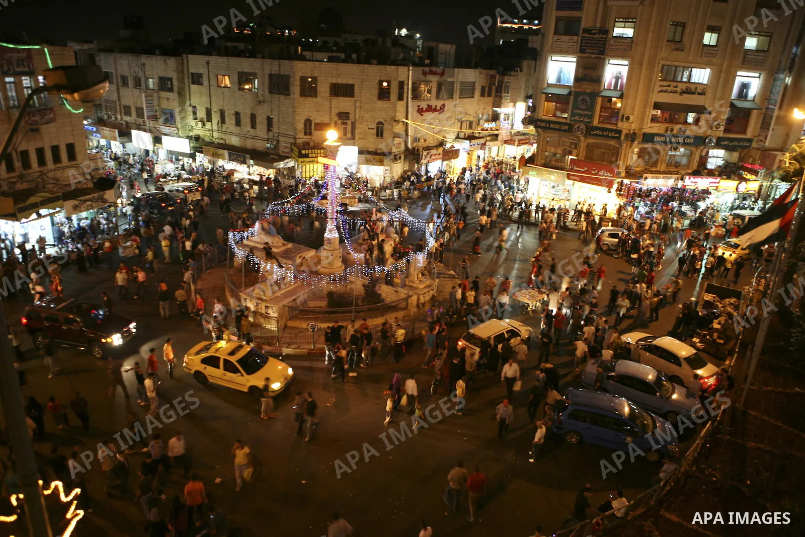 Palestinian residents of Ramallah throng the streets as they do their evening of shopping in the West Bank city on Sept. 9, 2010 on the eve of the Eid al-Fitr festivities marking the end of the Muslim holy month of Ramad...