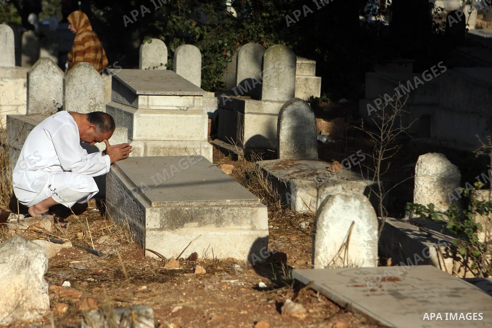 Palestinians visit the graves of their dead relatives during the early hours of the first day of the Muslim holiday Eid al-Fitr in the West Bank city of Ramallah September 10, 2010. Photo by Eyad Jadallah