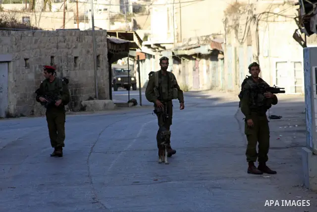 Israeli police guards walk in streets near the Tomb of the Patriarchs for morning Rosh Hashana (Jewish New Year) prayers, on Sept. 10, 2010, in the West bank town of Hebron, where Palestinian Muslims also pray at the sit...