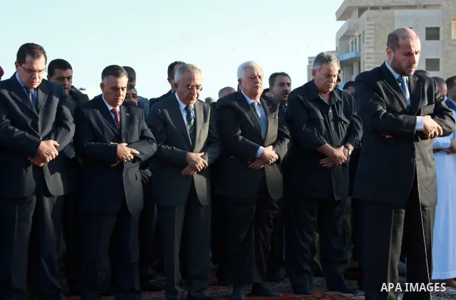 Palestinian president Mahmud Abbas and prime minister Salam Fayyad attend the early morning Eid Al-Fitr prayer at the Palestinian Authority headquarters in the West Bank city of Ramallah on Sept. 10, 2010 . Muslims acros...