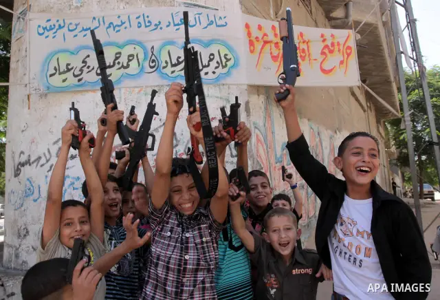 Palestinian children play with toy guns on the first day of Eid al-Fitr in in Gaza City,on Sept. 10, 2010. as Muslims around the world celebrate the first day of the holiday that marks the end of the fasting month of Ram...