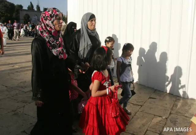 Palestinian Muslims in the courtyards of Al-Aqsa Mosque compound during the first day of Eid al-Fitr which marks the end of the Muslim fasting month of Ramadan, in the Al Aqsa Mosque Compound in Jerusalem's Old City, Fri...
