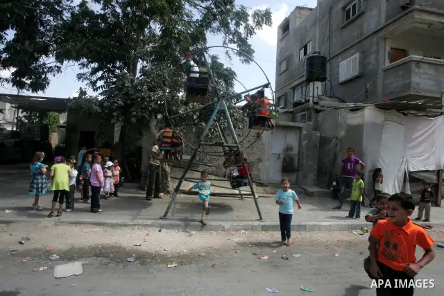 Palestinian children enjoy a ride on swings during the second day of Eid al-Fitr which marks the end of the Muslim fasting month of Ramadan, in the southern Gaza Strip town of Rafah, Sept. 11, 2010. Eid, one of the most...
