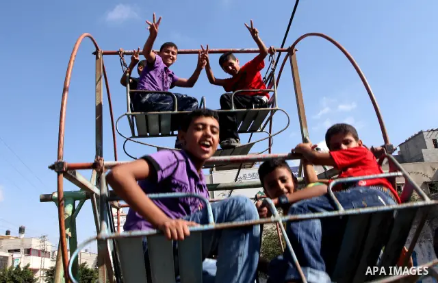 Palestinian children enjoy at a park during the second day of Eid al-Fitr which marks the end of the Muslim fasting month of Ramadan, in Gaza city, Sept. 11, 2010. Photo by Ashraf Amra