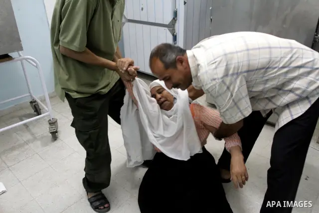 A Palestinian woman reacts as bodies lie in a hospital in Beit Hanoun , northern Gaza Strip, Sunday, Sept. 12, 2010. Hamas security officials say three Palestinians have been killed by Israeli tank fire in the northern G...
