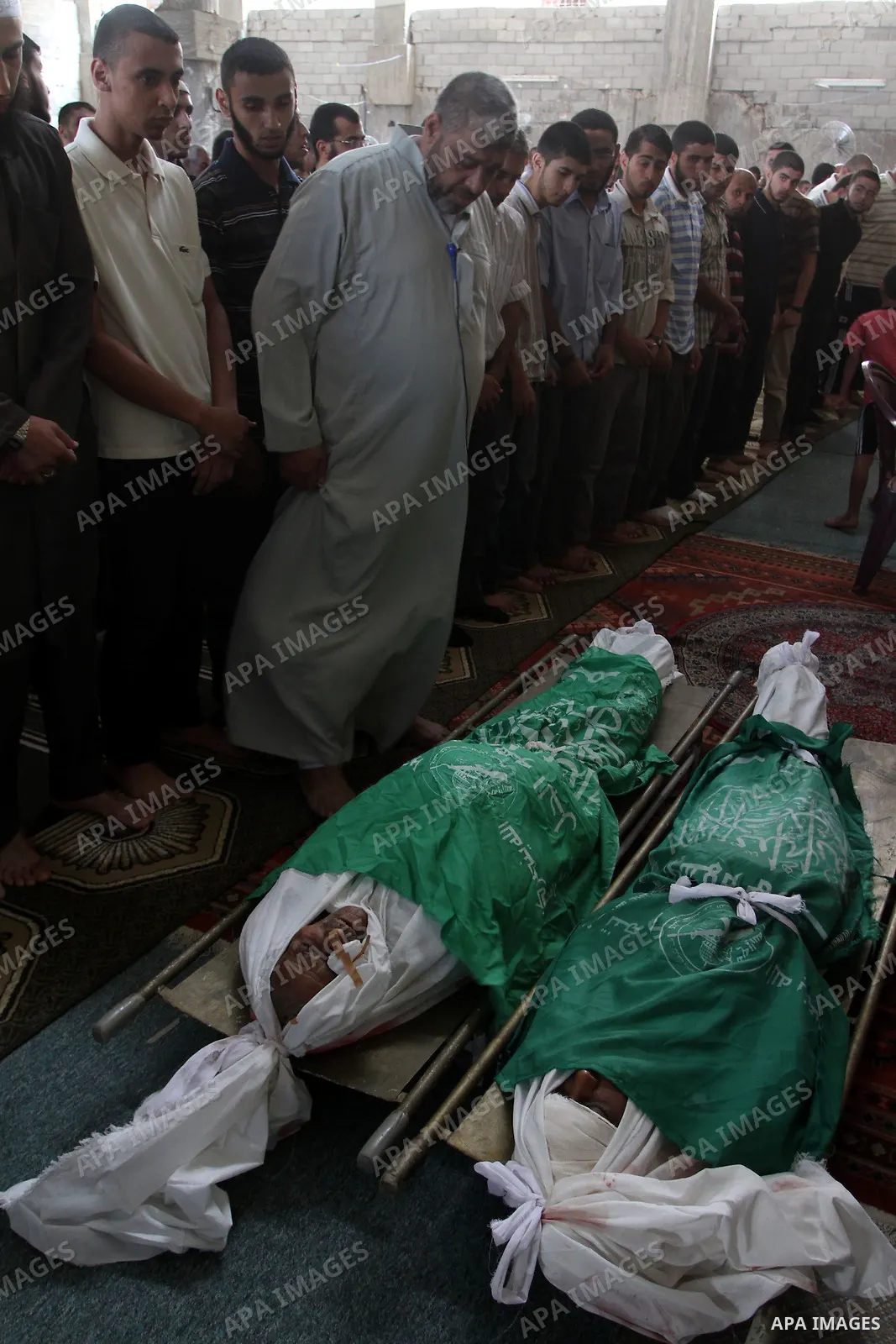 Mourners prepare to pray over the bodies of Palestinian 91-year-old farm caretaker Ibrahim Abdullah Abu Saeed and his teenaged grandson Hossam Khaled Abu Saeed during their funeral in nearby Jabalia in the northern Gaza...