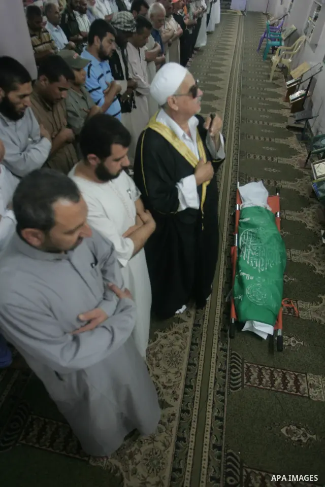Palestinian mourners pray at the body of Wajdi al-kadi, 23, who was killed in an Israeli airstrike on smuggling tunnels, in the southern Gaza Strip near Rafah, on September 15, 2010. Photo by Khaled Khaled