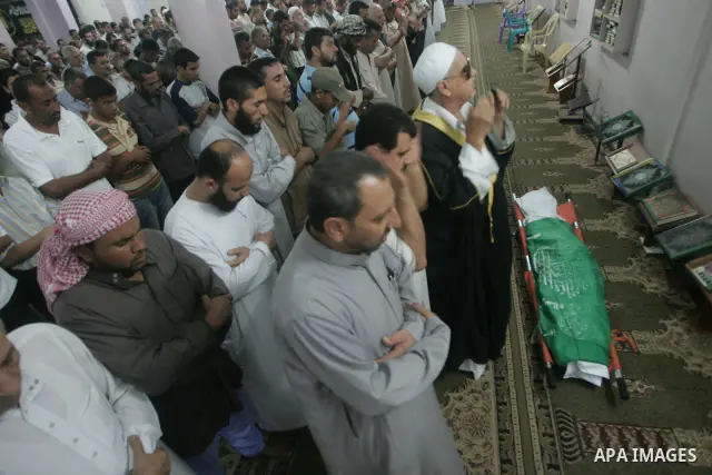 Palestinian mourners pray at the body of Wajdi al-kadi, 23, who was killed in an Israeli airstrike on smuggling tunnels, in the southern Gaza Strip near Rafah, on September 15, 2010. Photo by Khaled Khaled