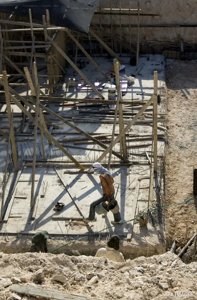 Palestinian laborers work on a construction site in the West Bank Jewish settlement of Maala Adomeem, on the outskirts of Jerusalem on September 15, 2010. Photo by Mahfouz Abu Turk