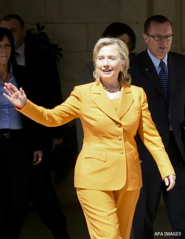 U.S. Secretary of State Hillary Clinton (C) waves as she leaves the Palestinian President headquarter in the West Bank town Ramallah, after her meeting with the Palestinian President Mahmoud Abbas (unseen) on Sept. 16,20...