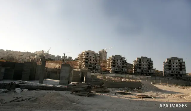 Palestinian laborers work on a construction site in the Jewish settlement of Har Homa, on the outskirts of Jerusalem on September 16, 2010. US Secretary of State Hillary Rodham Clinton arrived to the Palestinian Authorit...