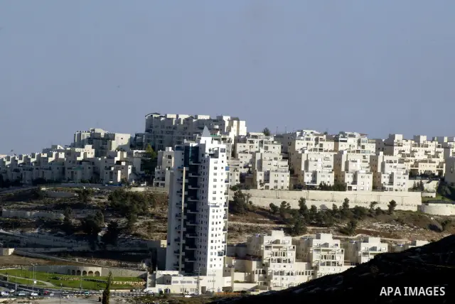 Palestinian laborers work on a construction site in the Jewish settlement of Har Homa, on the outskirts of Jerusalem on September 16, 2010. US Secretary of State Hillary Rodham Clinton arrived to the Palestinian Authorit...