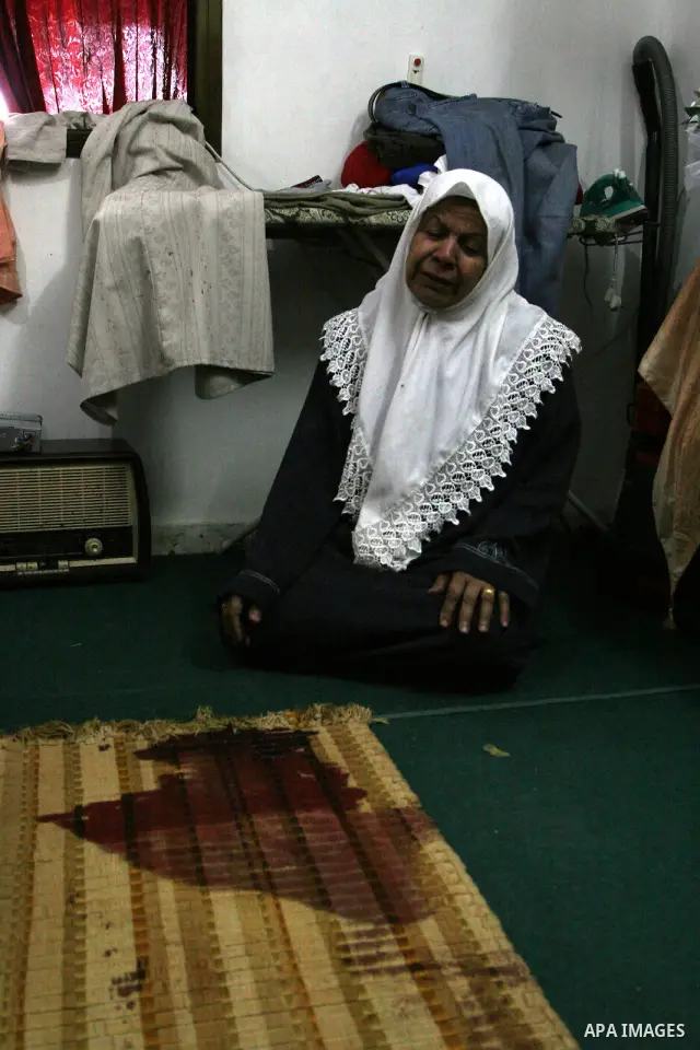 A Relative of Eyad Shilbaya, a 38-year-old local leader of the armed wing of the Islamist movement Hamas, weeps next to the spot where he was shot dead by Israeli soldiers on September 17, 2010 inside his bedroom in the...