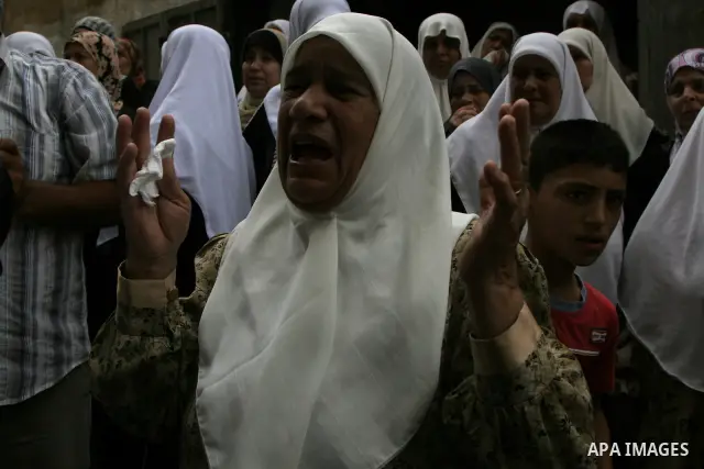 Family friends and relatives of Iyad Shilbaya, a 38-year-old local leader of the armed wing of the Islamist movement Hamas, mourn at his home after he was shot dead by Israeli soldiers on September 17, 2010 inside his be...