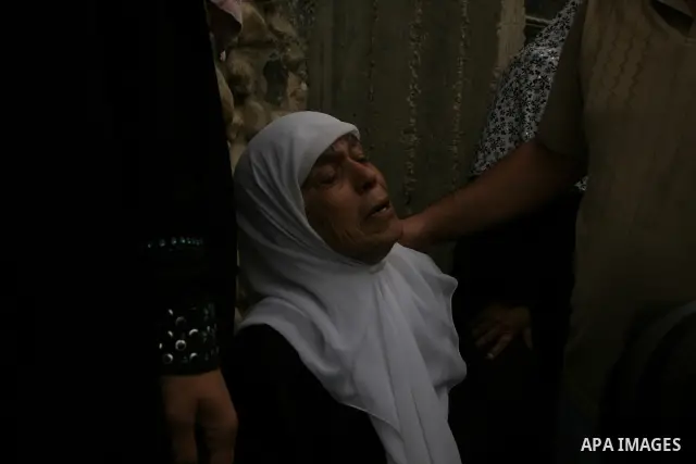 Family friends and relatives of Iyad Shilbaya, a 38-year-old local leader of the armed wing of the Islamist movement Hamas, mourn at his home after he was shot dead by Israeli soldiers on September 17, 2010 inside his be...